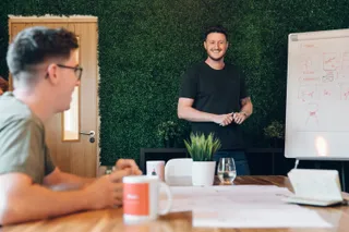 Andy smiles during a team meeting at the MadeByShape studio