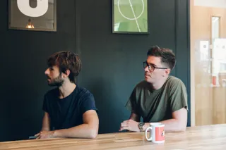 Mike and Tom look on at a presentation