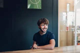 Tom laughs on his own in the meeting room