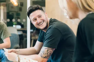 Andy Golpys smiling whilst playing cards with the MadebyShape team