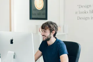 Close up of Tom smiling during the working day