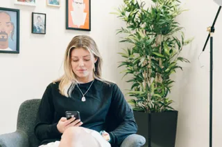 Kirsty checks social media during her lunch break