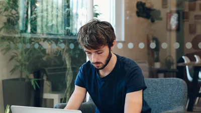 Tom busy working on his laptop